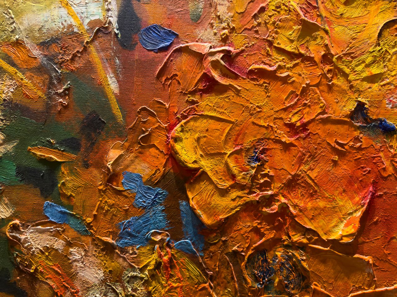 Closeup of a vibrant abstract oil painting showcasing bold, textured brushstrokes in warm colors.